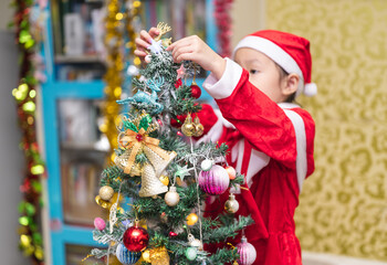 Happy a little girl with Xmas morning in decorated living room.Christmas