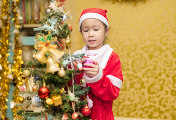 Happy a little girl with Xmas morning in decorated living room.Christmas