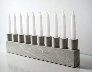 A sleek modern concrete menorah with nine pristine white candles for minimalist holiday celebrations