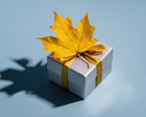 Gift Box With Golden Ribbon And Yellow Maple Leaf