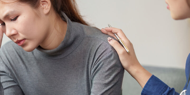 Mental Health Support. A compassionate therapist comforting a distressed woman during a session.