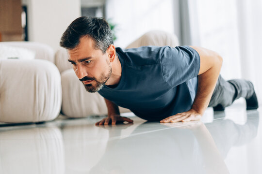 Middle aged man doing push ups at home for fitness