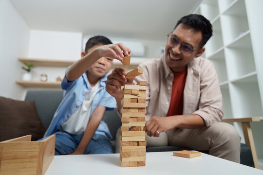 Family Life: Engaging playtime with father and son building a tower - Powered by Adobe