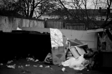 Trash container filled with various waste materials.