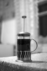 Coffee in a French press on a wooden table.