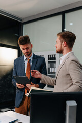 Diverse professionals collaborate on project analysis with financial graphs. Strategic teamwork and...