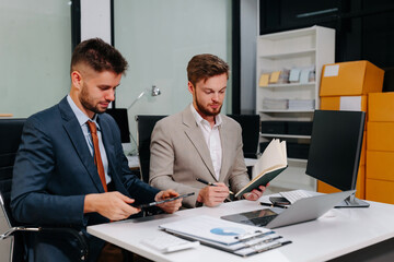 Diverse professionals collaborate on project analysis with financial graphs. Strategic teamwork and insights drive company growth and success.