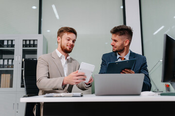 Diverse professionals collaborate on project analysis with financial graphs. Strategic teamwork and insights drive company growth and success.
