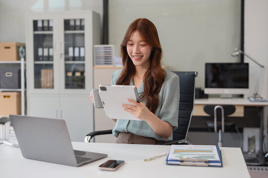 Business concepts, business women working in the work area with tablet and data sheets at the desk.