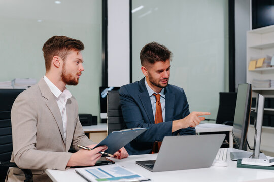 Diverse professionals collaborate on project analysis with financial graphs. Strategic teamwork and insights drive company growth and success.