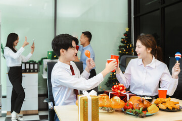 Asian people, celebrating together and gift exchange at Merry Christmas & Happy New Year. excited businessman feel happy work complete and celebration successful deal.