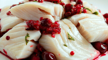 Indulge in fresh cod with vibrant cranberry sauce a culinary delight for festive holiday gatherings
