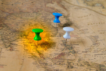 The color pins on old map,point on location.