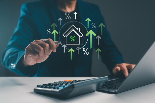 A person analyzing financial growth in real estate, using a calculator and laptop, with graphics of percentages and upward arrows in the background.