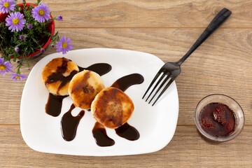 Curd fritters with chocolate and strawberry jam.