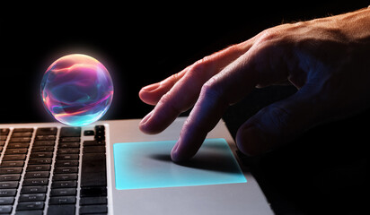 Finger interacting with holographic glowing sphere above laptop touchpad. Concept of AI...