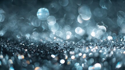 Close-up of metallic light orbs and glitter in a dreamy cool-toned abstract scene