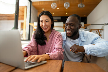 Man and woman working remotely using laptop. Male female freelancers working together. Digital nomad
