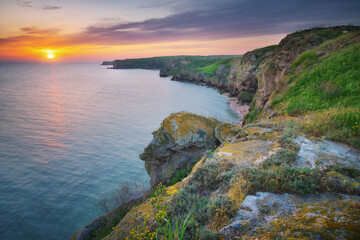 Sunset on cliffs. Beautiful spring nature and sea landscape.