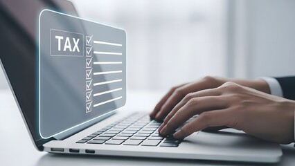 Filing taxes online hands on laptop with tax form displayed on screen