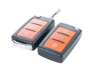 Two car keys on black background, one slightly angled