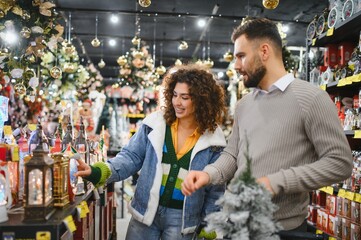 Happy couple shopping for christmas decorations in store