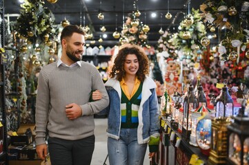 Couple shopping for christmas holiday decorations in store