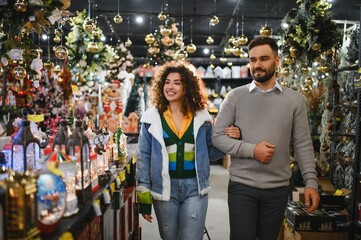 Couple shopping christmas decorations in store market