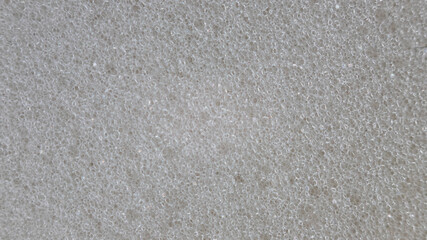 Close-up of light grey foam material texture