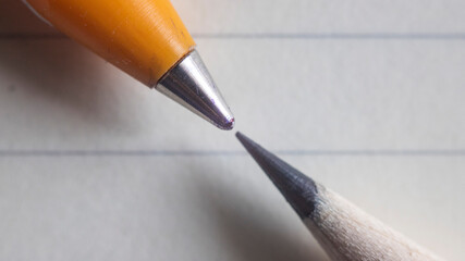 A macro shot of pen and pencil tips alignment