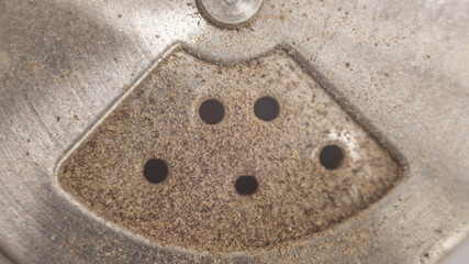 Macro shot of pepper mill’s dispensing holes