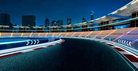 3d rendering empty illuminated racetrack with city skyline at night