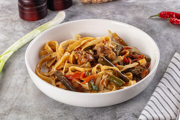 Asian cuisine udon with chicken and vegetables