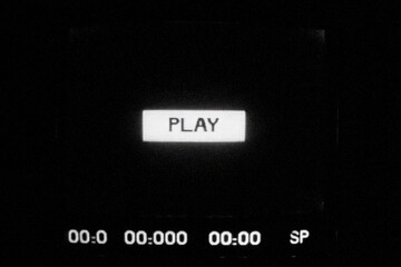 A black and white image features a "PLAY" button and a timer display at the bottom