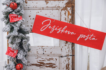 Santa post, christmas decorations on a rustic wooden table.