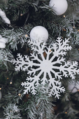 white snow on a christmas tree. christmas decorations. winter holiday concept. new year 's christmas. winter background. christmas tree. winter holidays