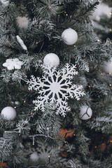 white snow on a christmas tree. christmas decorations. winter holiday concept. new year 's christmas. winter background. christmas tree. winter holidays