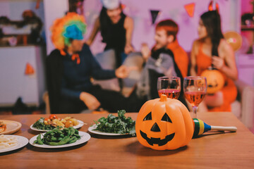 Joyful office Halloween party with coworkers in costumes, celebrating with drinks and laughter, fostering teamwork and festive spirit