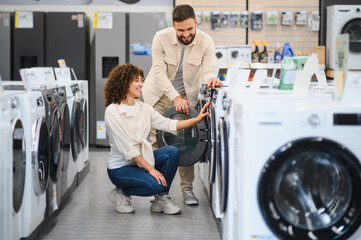 Couple exploring home appliances in electronics store