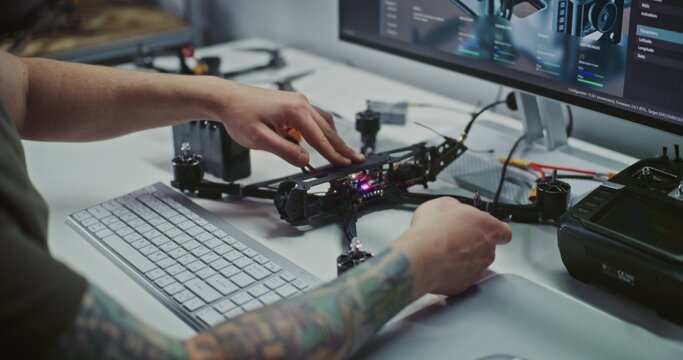Technician Building and Testing Drone. Man Hands on Assembling and Connecting Motor Systems FPV Drone, With Digital Interface Visible. Concept of Detailed, Integrated Process of Building Modern UAV.