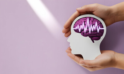 Brain health awareness with vibrant purple brain in head profile held in hands