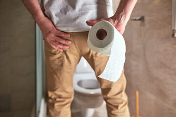 Man with urge to go to the toilet at home.