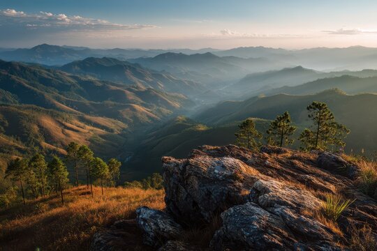 Crepuscular rays illuminate misty Laos hills viewed from a northern Phongsaly summit