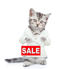 Cute kitten wearing bathrobe standing on hind legs and holding signboard with labeled "sale". Isolated on white background