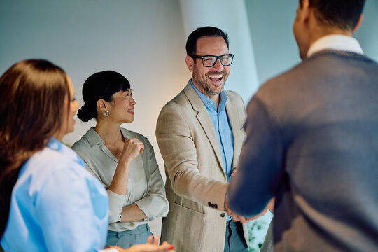 Smiling business people shaking hands, diverse group meeting, collaboration, agreement, teamwork, success concept