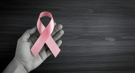 Hand Holding Pink Ribbon Symbolizing Breast Cancer Awareness And Support, Capturing Hope, Strength, And The Spirit Of Community Solidarity