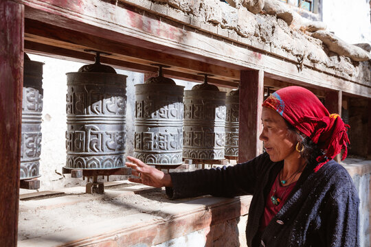 Local woman spinning prayer wheels, Nepal