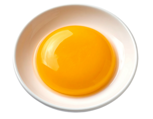 Overhead shot of a glossy, spherical egg yolk nestled in a white, ceramic bowl, against a black background