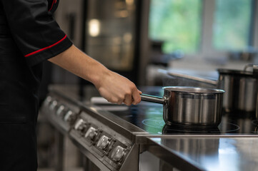 Unrecognizable chef working in restaurant kitchen
