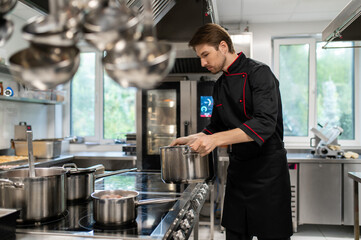 Male culinary chef working in restaurant workspace